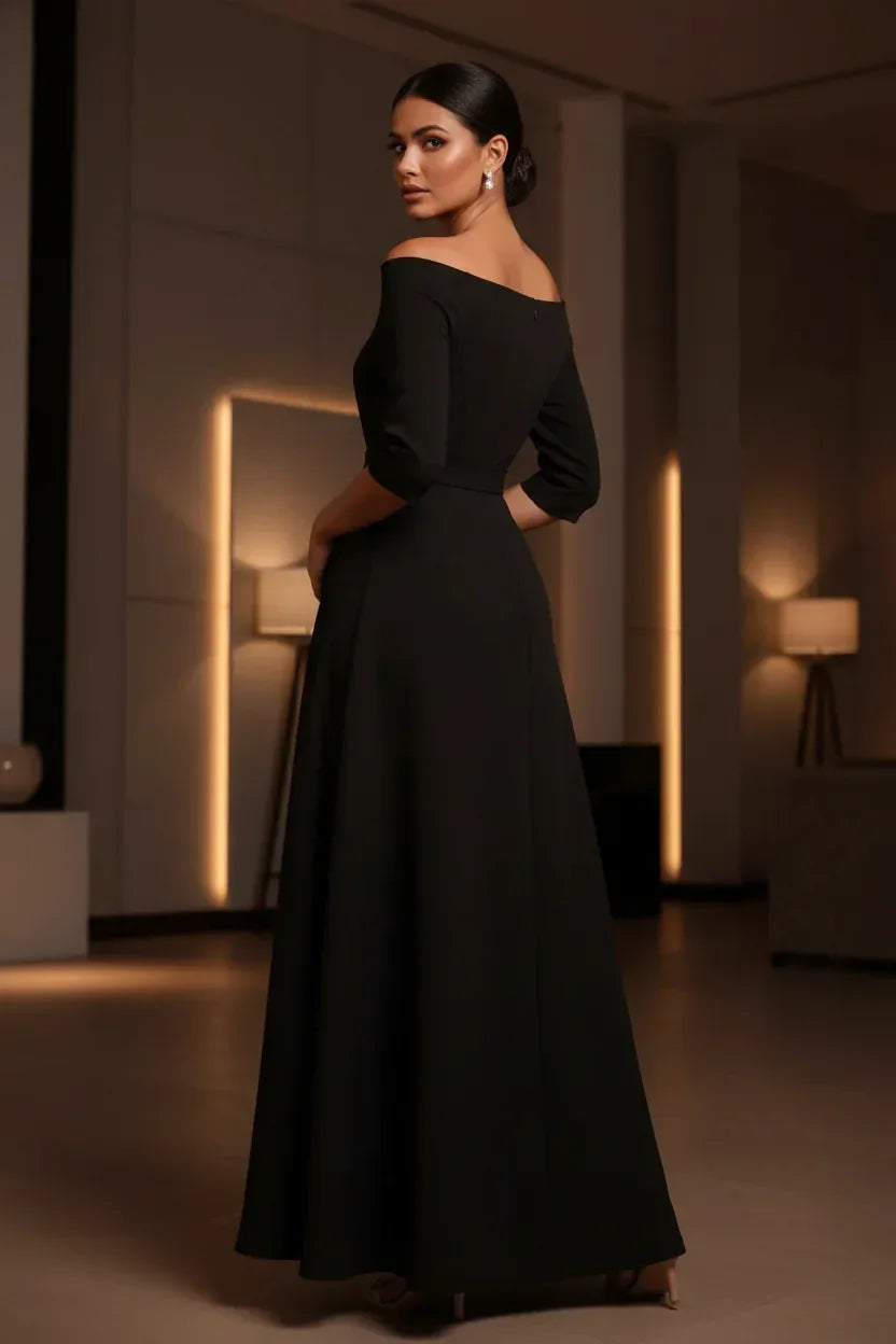 Woman in black off-shoulder belted maxi dress - elegant evening lifestyle shot